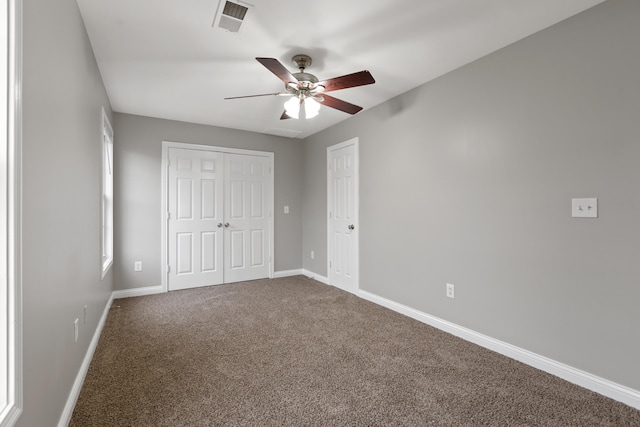 unfurnished bedroom with carpet flooring, a closet, and ceiling fan