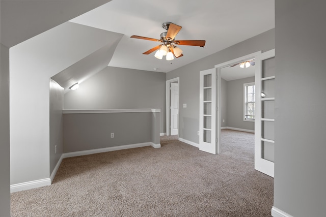 bonus room featuring carpet flooring, ceiling fan, and french doors