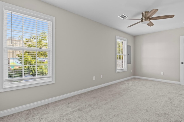 carpeted empty room featuring plenty of natural light and ceiling fan