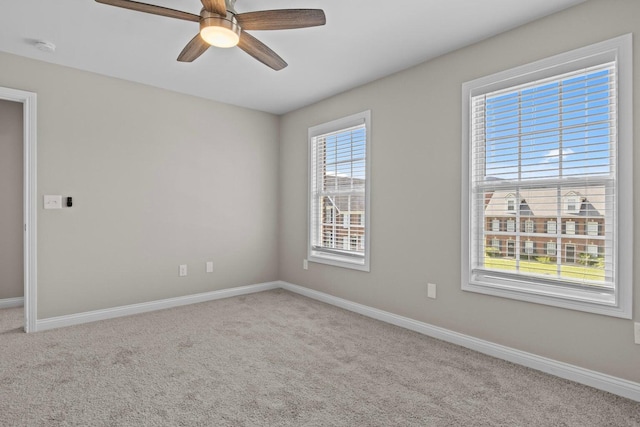 empty room with ceiling fan and light colored carpet