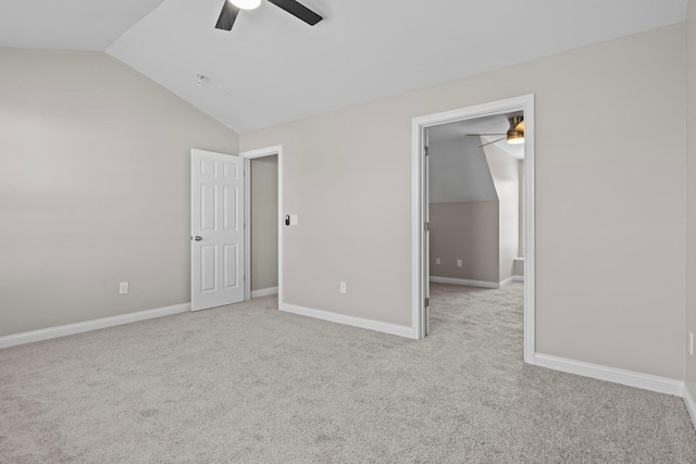 unfurnished bedroom with light colored carpet, vaulted ceiling, and ceiling fan