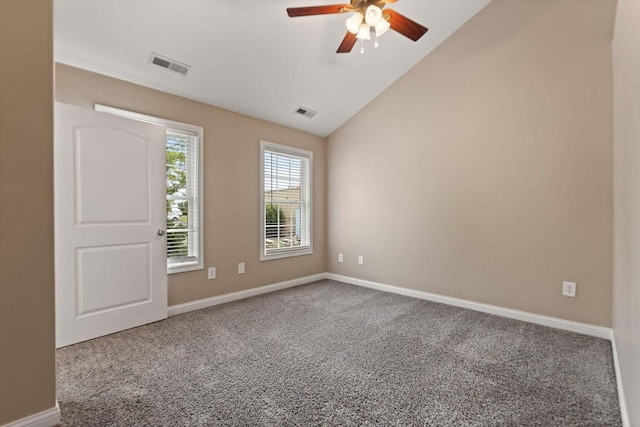 carpeted spare room with ceiling fan and lofted ceiling