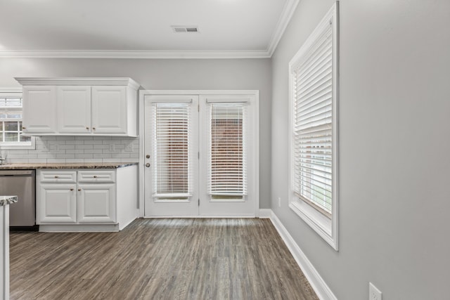 kitchen featuring backsplash, stainless steel dishwasher, ornamental molding, wood-type flooring, and white cabinets