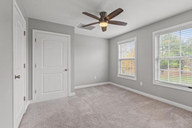 spare room with light carpet and ceiling fan