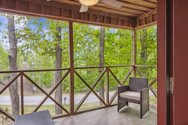 unfurnished sunroom with ceiling fan