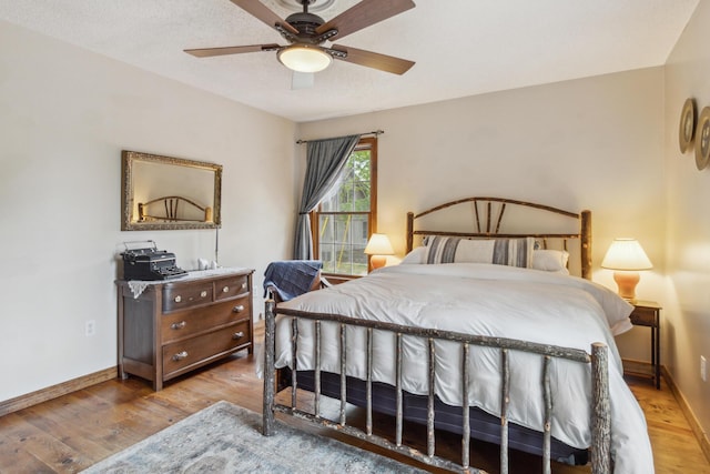 bedroom with ceiling fan and light hardwood / wood-style floors