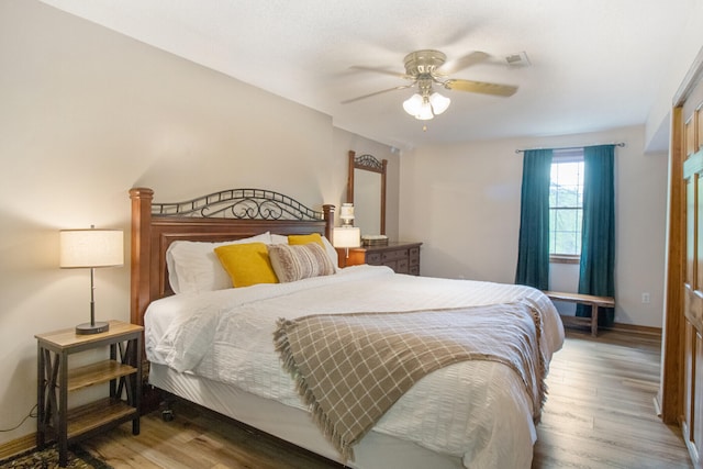 bedroom with ceiling fan and hardwood / wood-style flooring