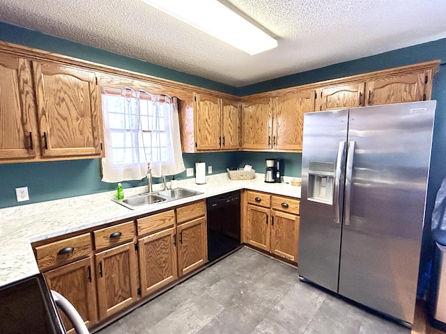 kitchen featuring dishwasher, stove, sink, a textured ceiling, and stainless steel fridge