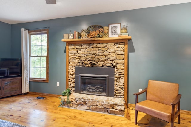 living area with a fireplace and light hardwood / wood-style floors