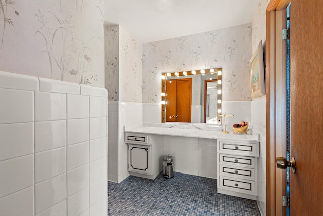 bathroom featuring tile walls, tile patterned flooring, and vanity