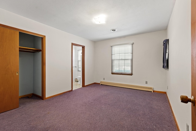 unfurnished bedroom with connected bathroom, a closet, baseboard heating, and carpet floors