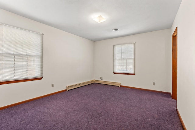 empty room featuring baseboard heating and carpet flooring