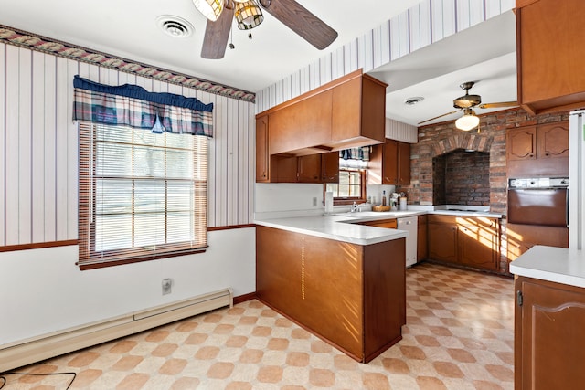 kitchen featuring ceiling fan, baseboard heating, dishwasher, and kitchen peninsula