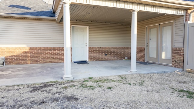 entrance to property featuring a patio