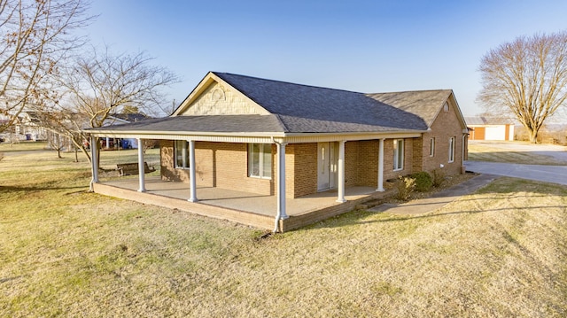 back of house featuring a yard and covered porch