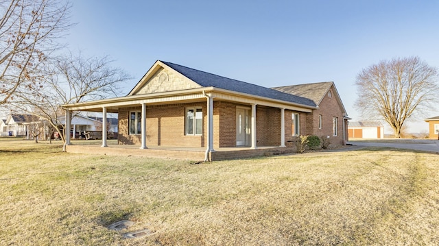 view of side of property with covered porch and a lawn