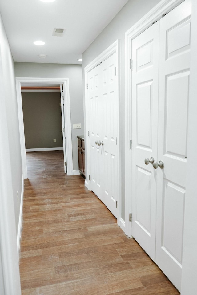 hall with light hardwood / wood-style floors