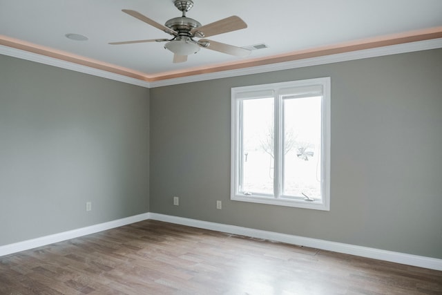 empty room with crown molding, light hardwood / wood-style flooring, and ceiling fan