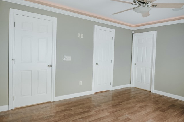 unfurnished bedroom with crown molding, ceiling fan, and hardwood / wood-style floors