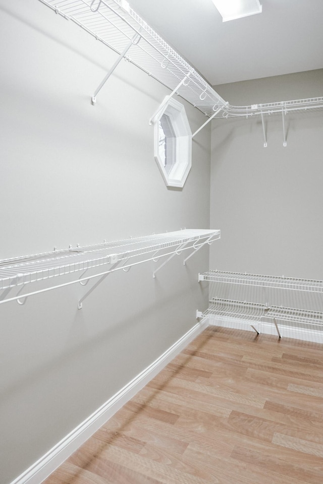 spacious closet featuring hardwood / wood-style flooring