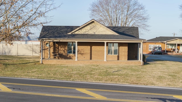 view of front facade with a front lawn and a porch