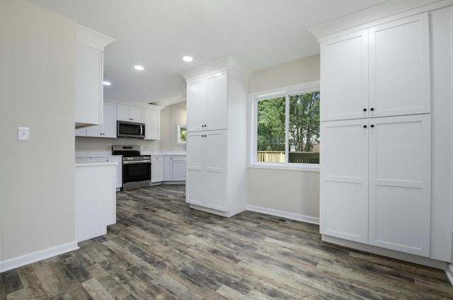 kitchen featuring white cabinetry, dark hardwood / wood-style flooring, and appliances with stainless steel finishes