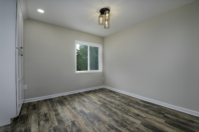 spare room with dark wood-type flooring