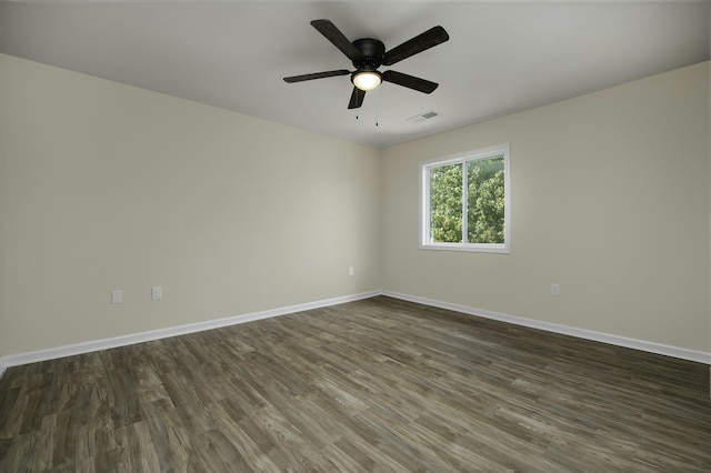 empty room with dark hardwood / wood-style flooring and ceiling fan