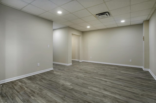 unfurnished room featuring a drop ceiling and dark hardwood / wood-style flooring