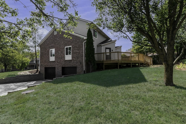 view of home's exterior featuring a yard, a deck, and a garage