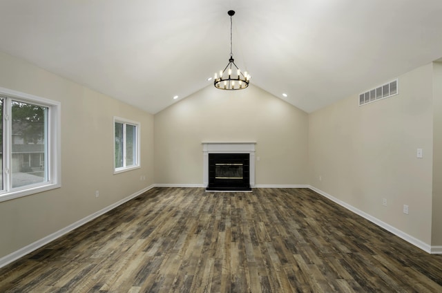 unfurnished living room with dark hardwood / wood-style flooring, a chandelier, and lofted ceiling