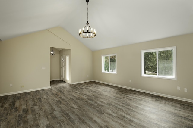 empty room featuring dark hardwood / wood-style flooring, vaulted ceiling, and an inviting chandelier