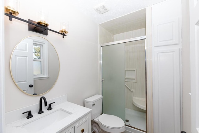 bathroom featuring visible vents, a stall shower, vanity, and toilet