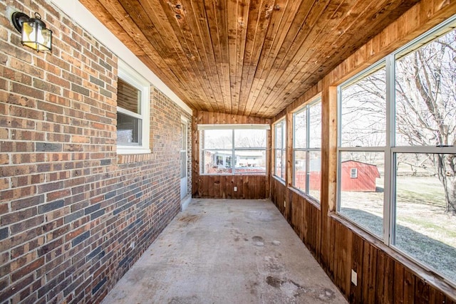 unfurnished sunroom featuring wood ceiling