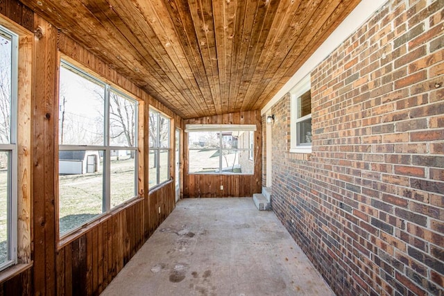 unfurnished sunroom with wood ceiling