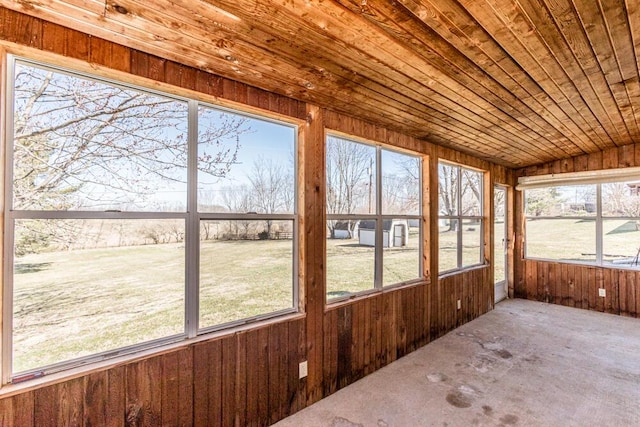 unfurnished sunroom with lofted ceiling and wood ceiling