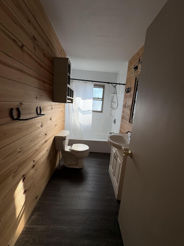 full bathroom with toilet, wood walls, shower / washtub combination, wood-type flooring, and vanity