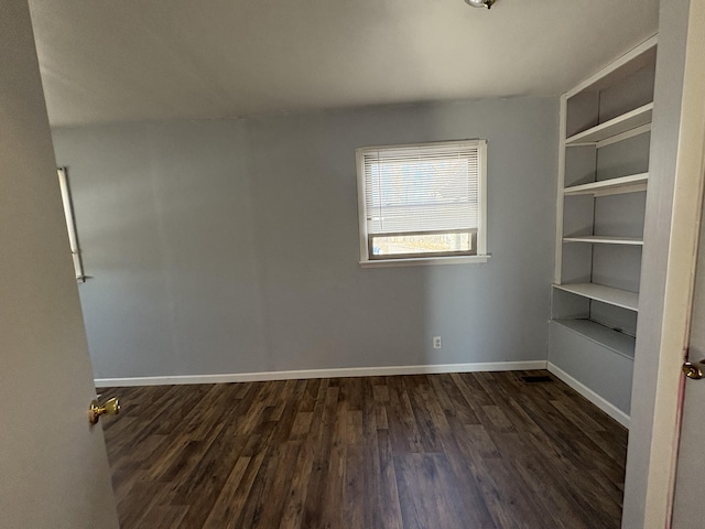 unfurnished room featuring dark hardwood / wood-style floors