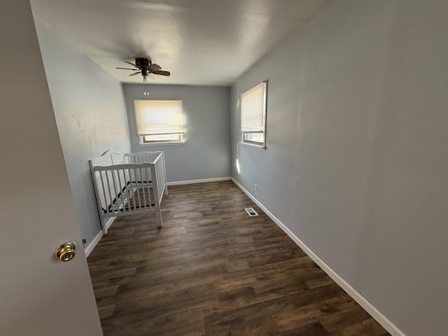 spare room with ceiling fan and dark hardwood / wood-style floors