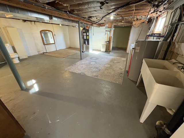 basement featuring sink and water heater