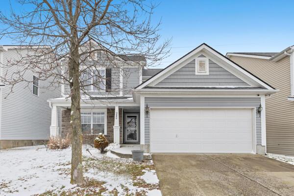 view of property featuring a porch and a garage