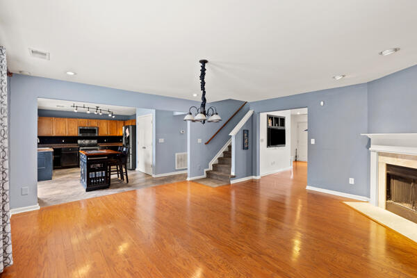 unfurnished bedroom featuring hardwood / wood-style floors, ceiling fan, and a spacious closet