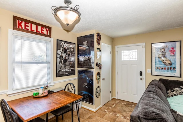 dining room featuring a textured ceiling