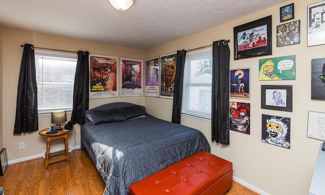 bedroom featuring hardwood / wood-style floors and a textured ceiling