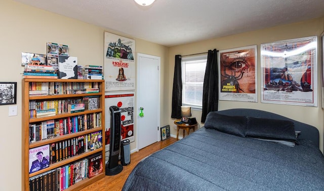 bedroom with hardwood / wood-style flooring