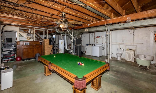 playroom featuring concrete floors, washer and clothes dryer, and ceiling fan