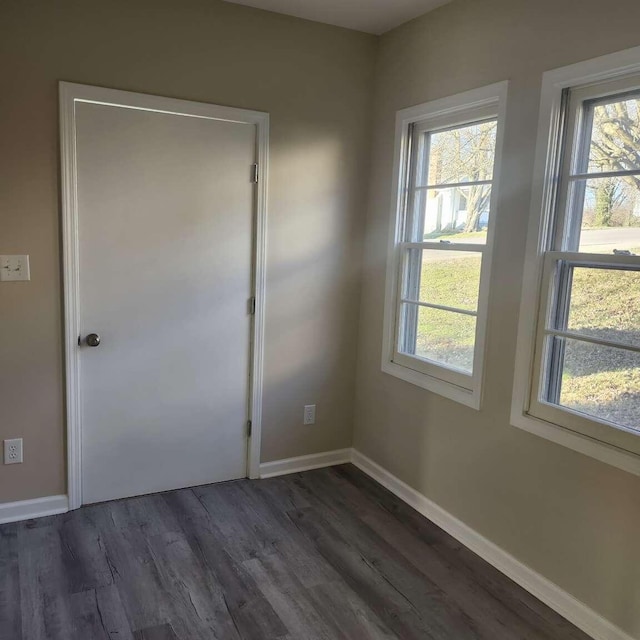 unfurnished room with dark hardwood / wood-style floors