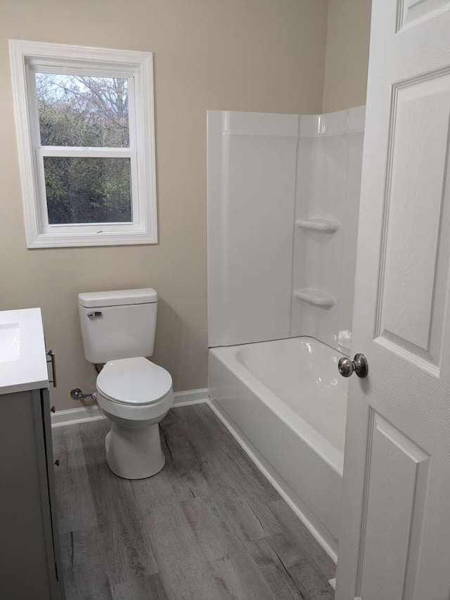 full bathroom featuring vanity, shower / bathtub combination, toilet, and wood-type flooring