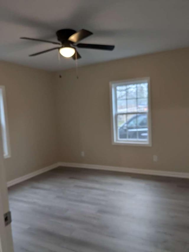 spare room featuring hardwood / wood-style flooring and ceiling fan