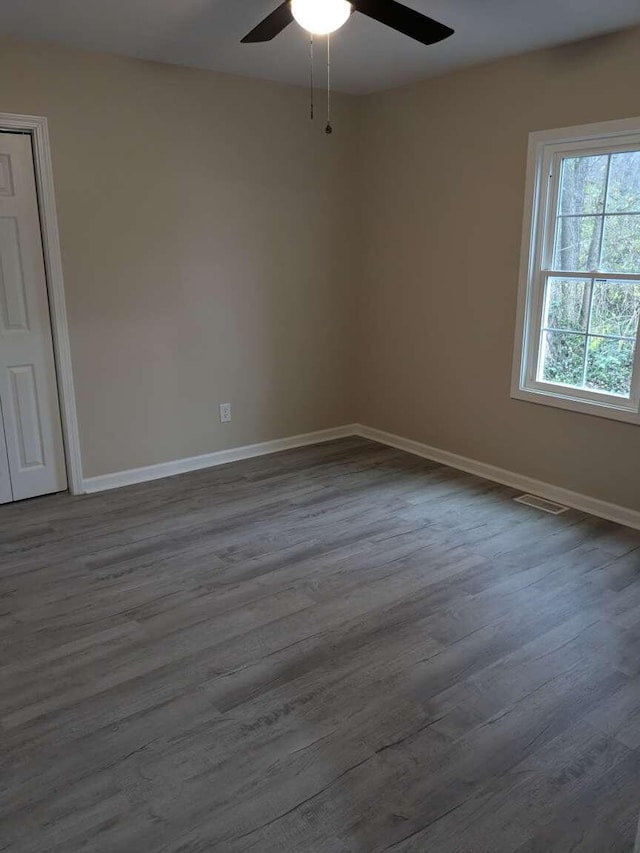 unfurnished room featuring hardwood / wood-style flooring and ceiling fan